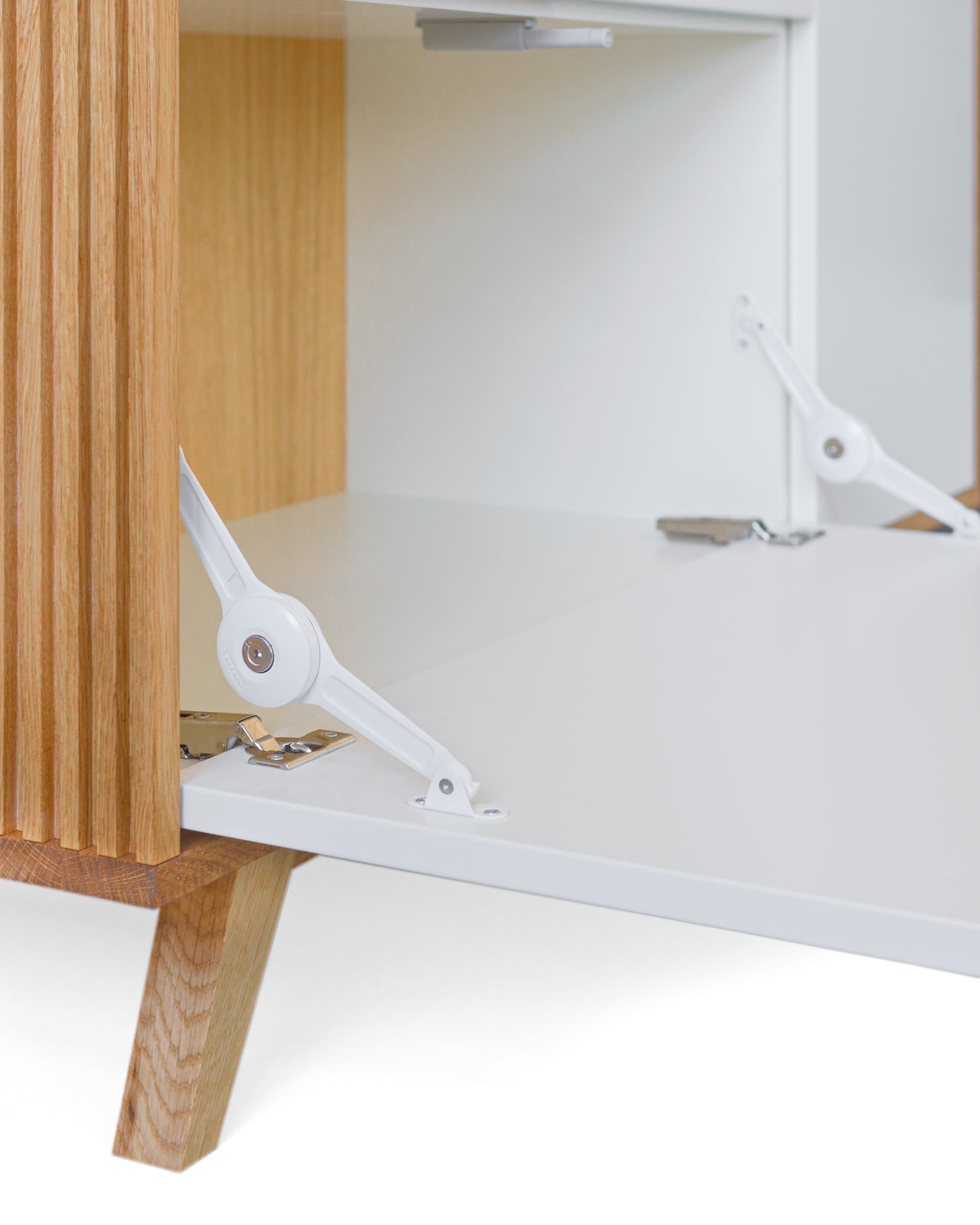 Highboard in Eiche weiß:Passende Scharniere:Wir setzen ausschließlich hochwertige Scharniere in Ihr Highboard ein. Die horizontalen Klappen werden zusätzlich gestützt.