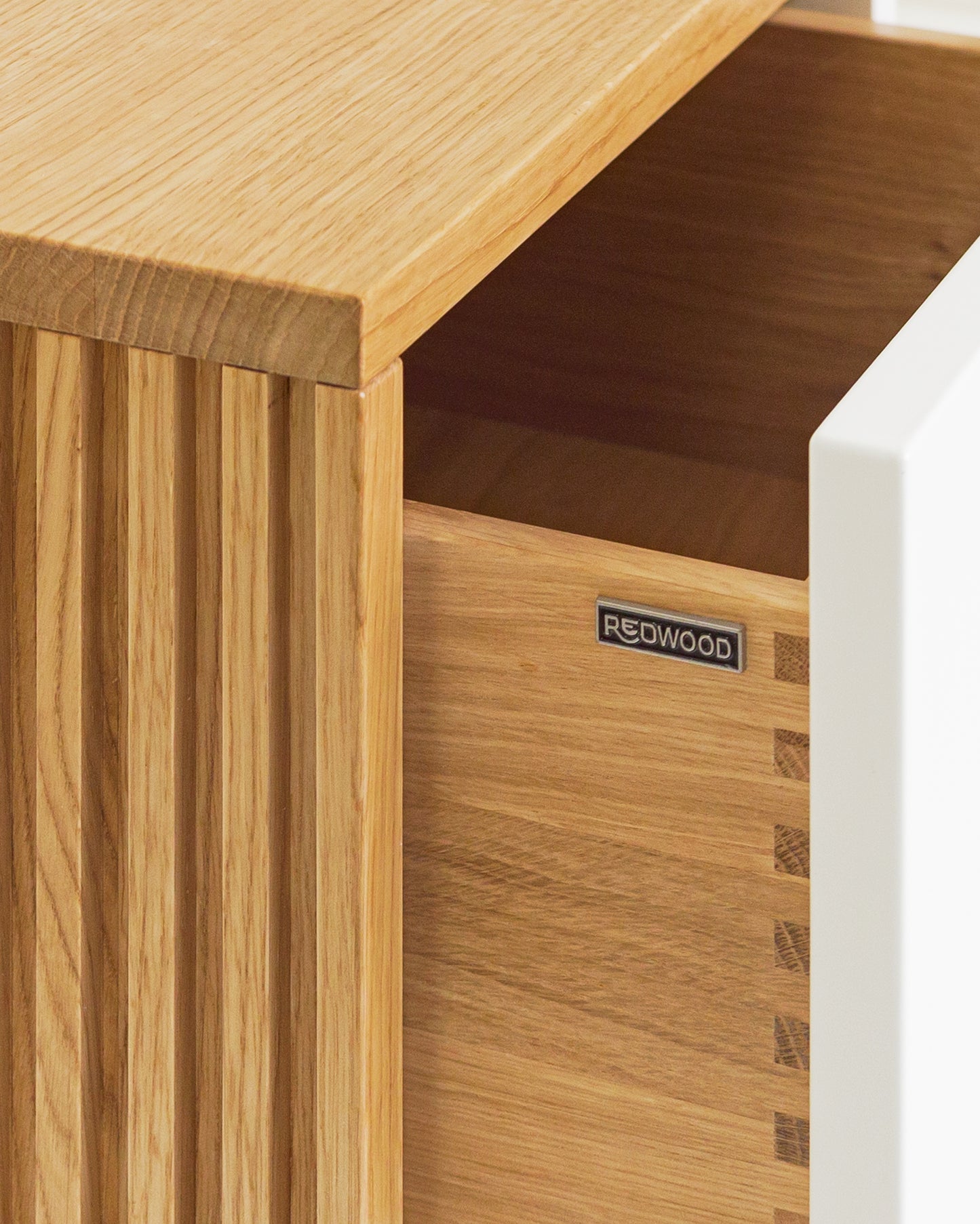 Lowboard in Eiche weiß:Schubladen in Massivholz:Die Verwendung von Massivholz für die Schubladen und die unterseitige (also nicht sichtbare) Befestigung der Auszüge sorgen nicht nur für ein hochwertiges Design, sondern auch für maximale Stabilität und Langlebigkeit.